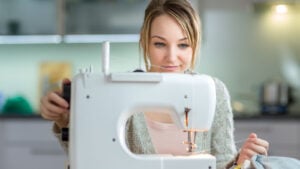 Smiling woman sitting at a sewing machine