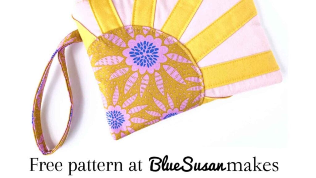 A handmade Sunrise Zipper Pouch with a vibrant sunburst design made from colorful fabric scraps. A brilliant and free scrap-friendly sewing pattern for a spring accessory.